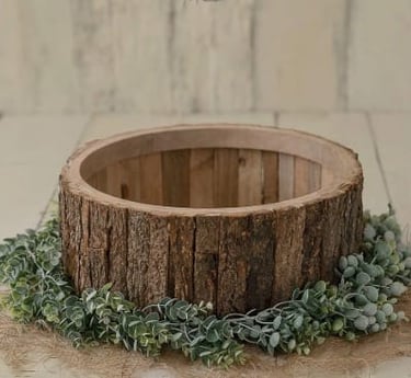 Rustic log wooden bowl prop for newborn photography with green leaves and burlap.